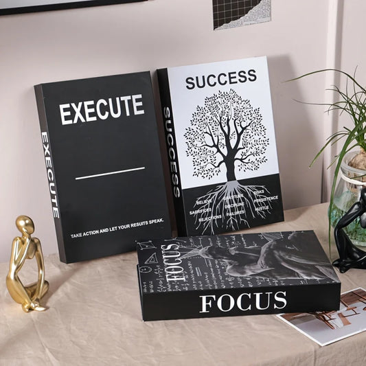 Three motivational books titled 'Execute', 'Success', and 'Focus' on a surface with decorative items.