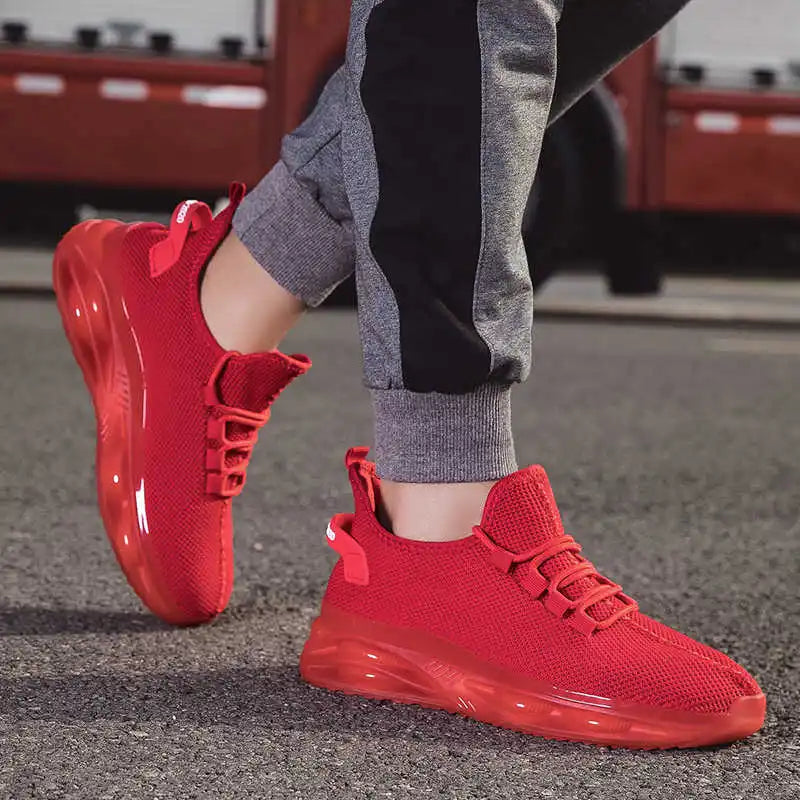Red sneakers worn on a blurred street background