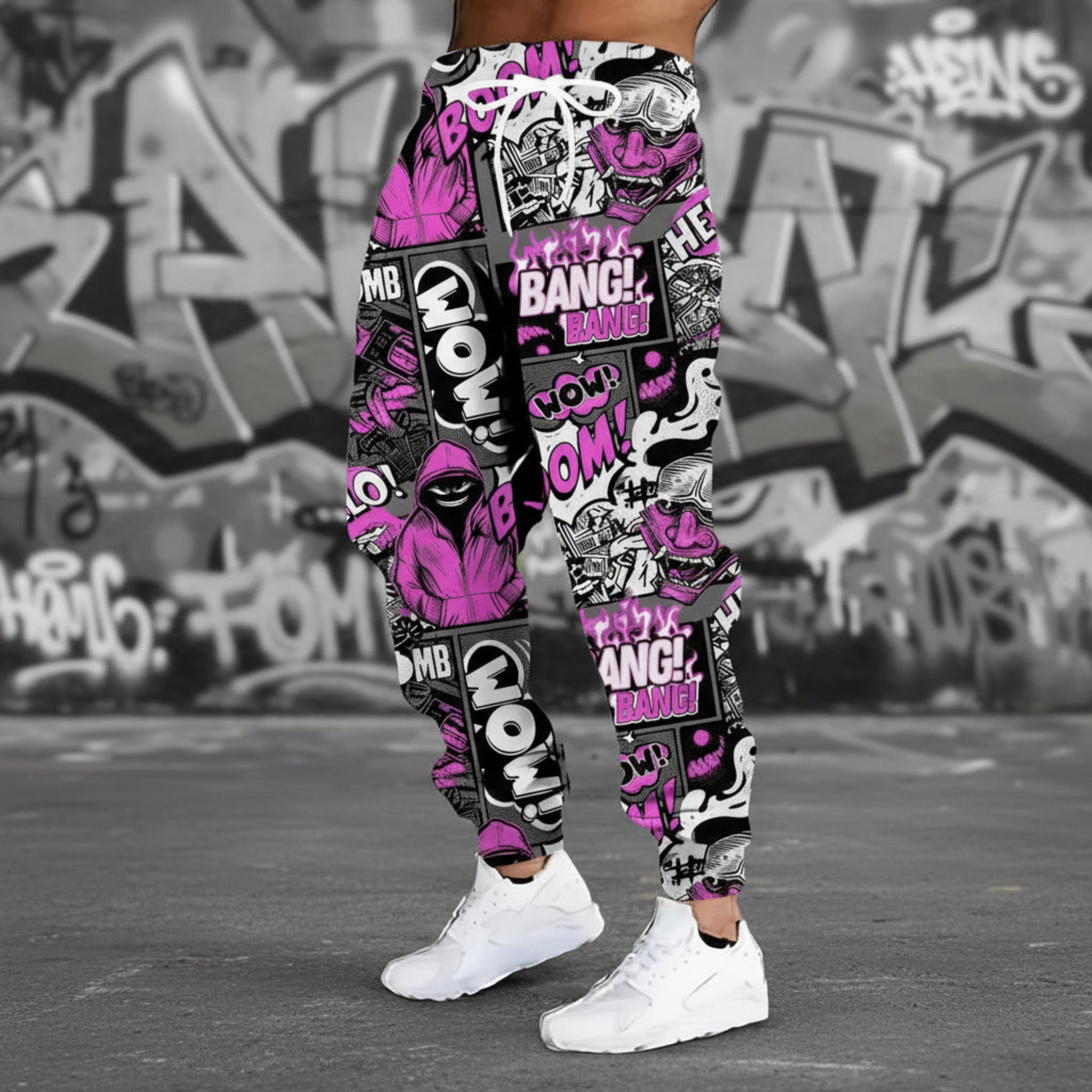 Colorful graphic jogger pants with text and patterns on a gray background