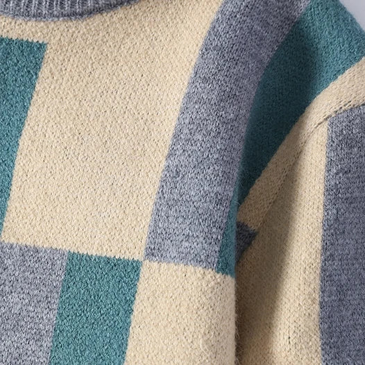 Close-up of a textured fabric with blue, gray, and beige checkered pattern on a white background