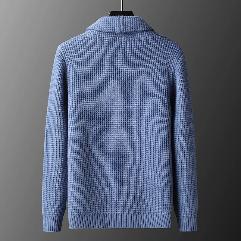 Blue textured sweater on a gray background