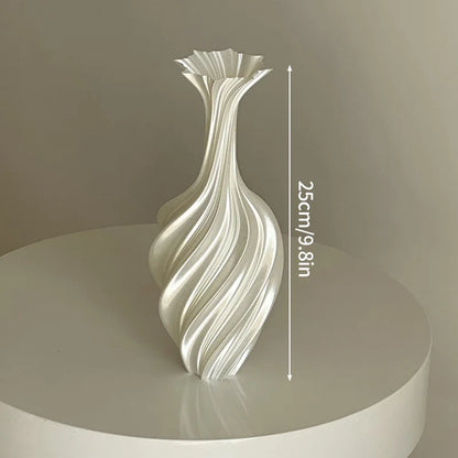Decorative vase with wavy design on a round platform against a plain background