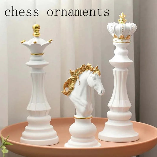 Decorative chess pieces with gold accents on a pink surface