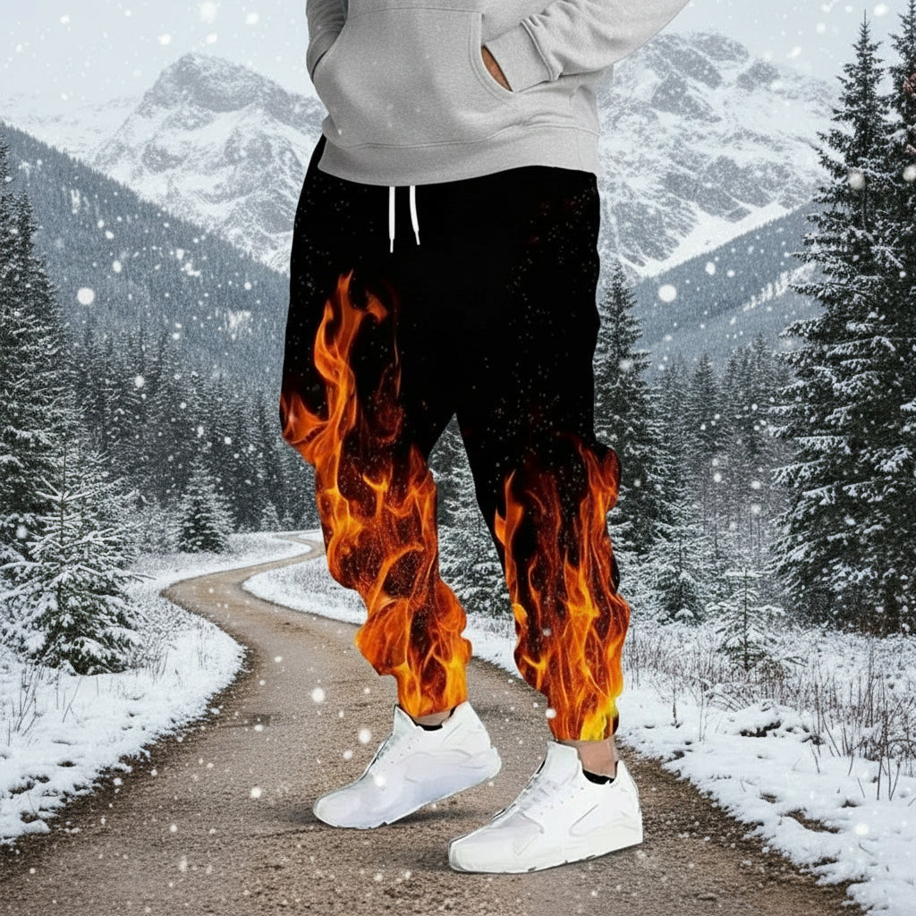 Black pants with flame design worn by a person on a gray background