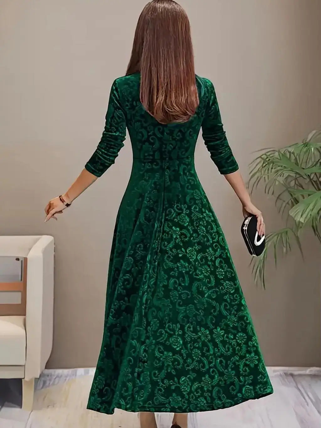 Woman wearing a green patterned dress in an indoor setting