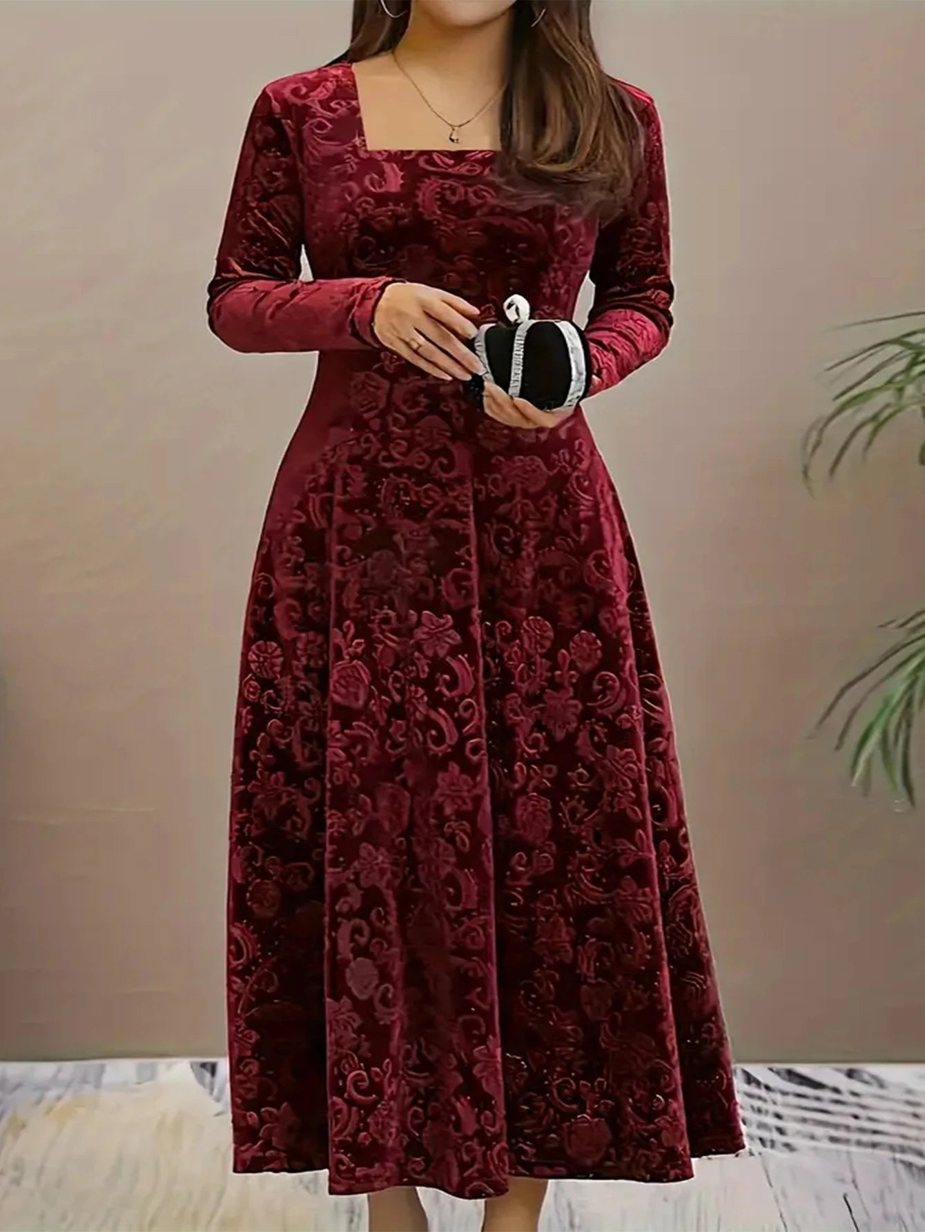 Red lace dress worn by a person against a neutral background