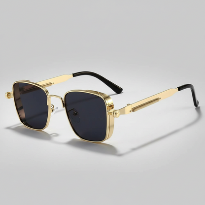 Gold-framed sunglasses with black lenses on a light gray background