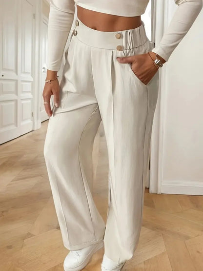 Person wearing a white outfit with wide-leg pants indoors.