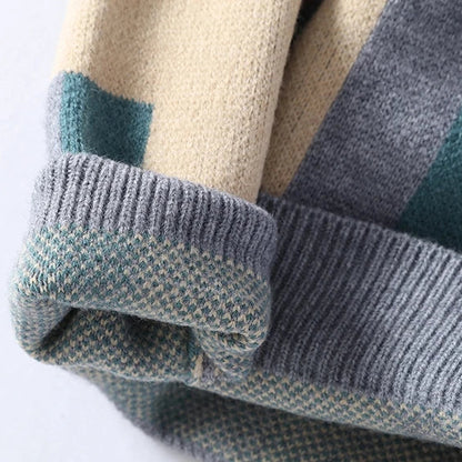 Close-up of a folded sweater with a checkered pattern on a white background