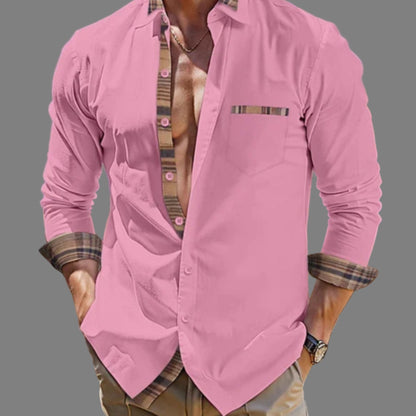 Pink shirt with plaid accents worn by a person on a gray background