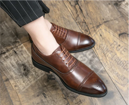 Brown dress shoes worn on a wooden floor