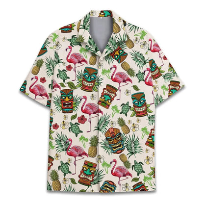 Hawaiian shirt with tropical pattern featuring flamingos, tiki masks, and pineapples on a white background.