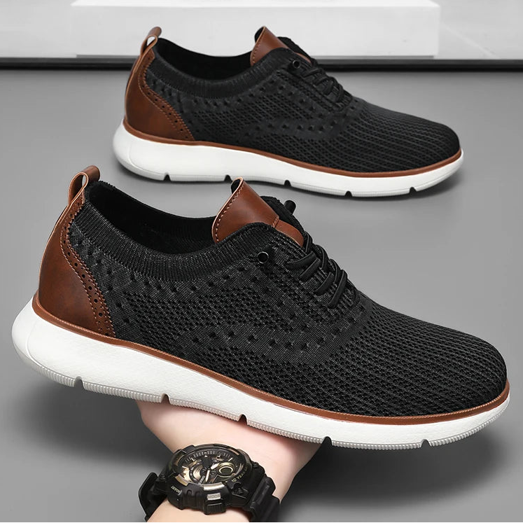 Black and brown sneakers with a white sole on a gray background