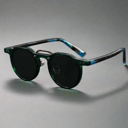 Sunglasses with green and blue frame on a dark gray background