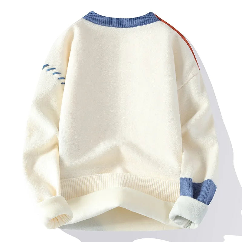 White sweater with blue and red accents on a white background