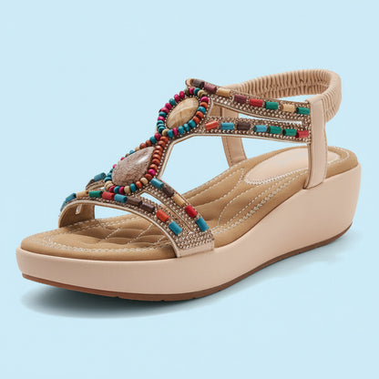 Beige wedge sandal with colorful beading on a white background