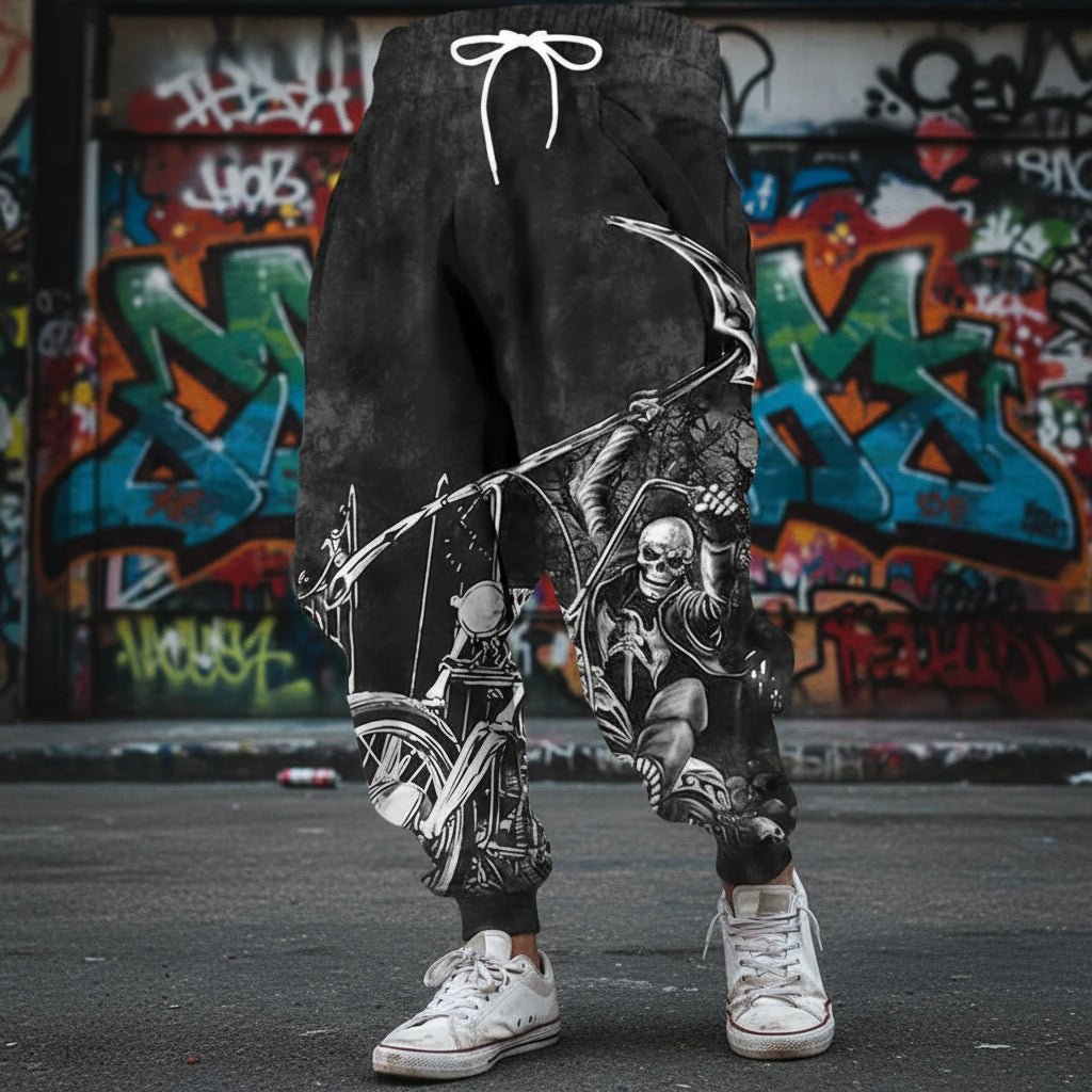 Black shorts with a graphic design of a skeleton on a motorcycle against a textured wall.