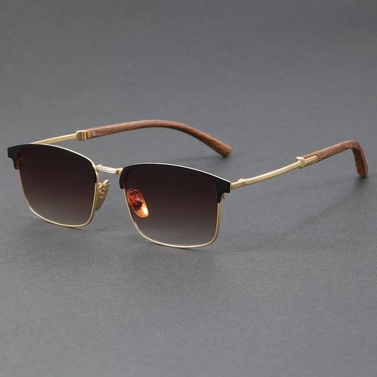 Sunglasses with gold frame and brown gradient lenses on a gray background