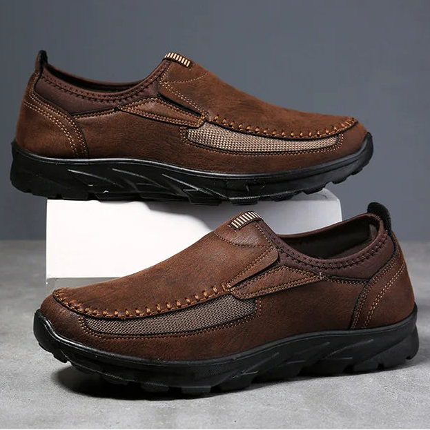 Brown leather shoes on a gray background