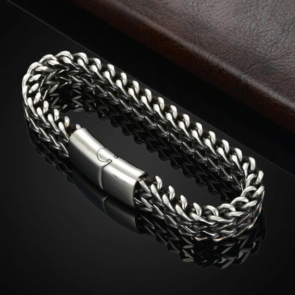 Silver braided bracelet on a dark background