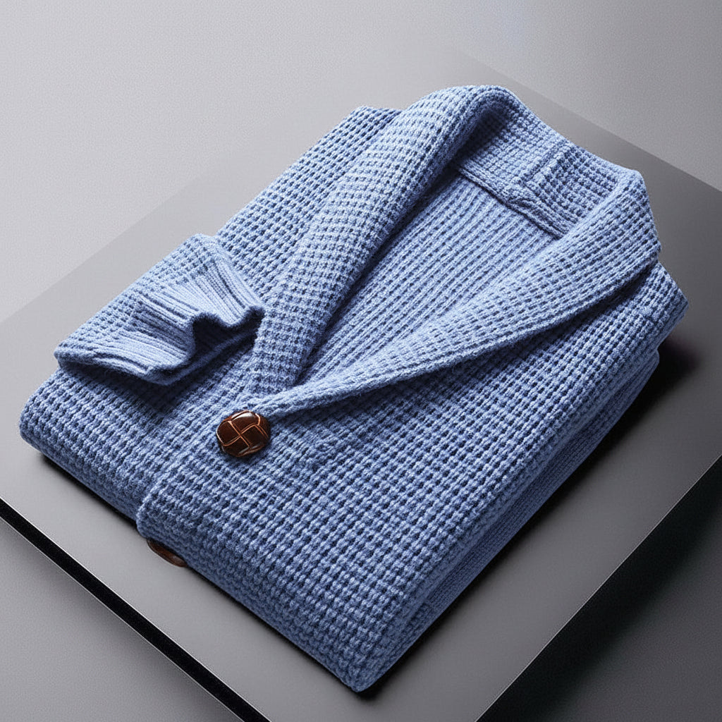 Folded blue robe with a brown button on a gray surface, with 'The Style of Boy City' branding.
