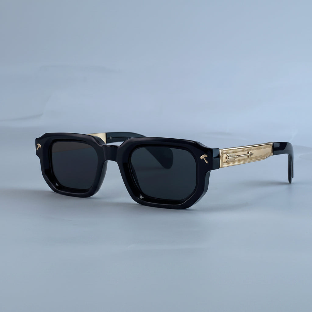 Black sunglasses with gold accents on a light blue background, featuring the brand 'KIM7KIM'.