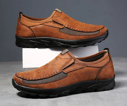 Pair of brown leather shoes on a gray background