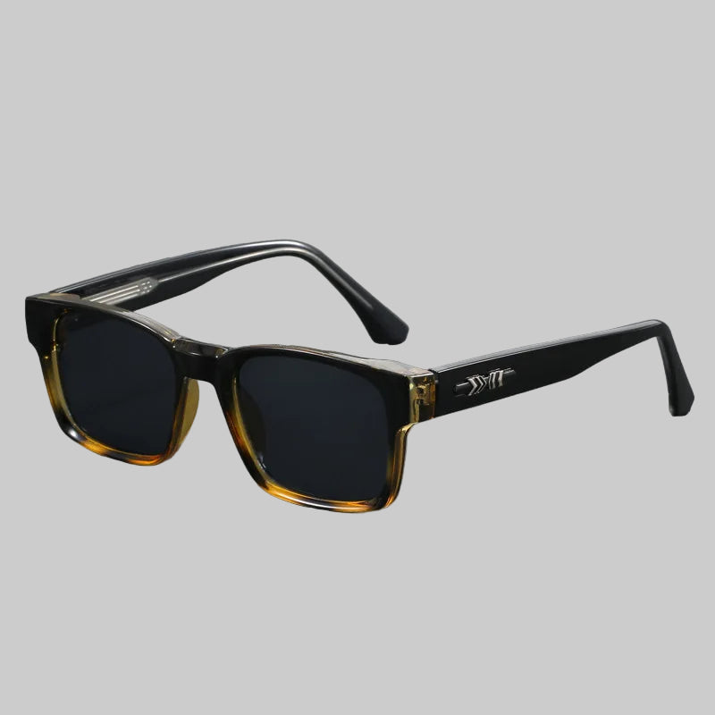 Sunglasses with black and gold frame on a gray background