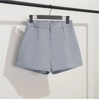 Gray shorts on a hanger against a white background