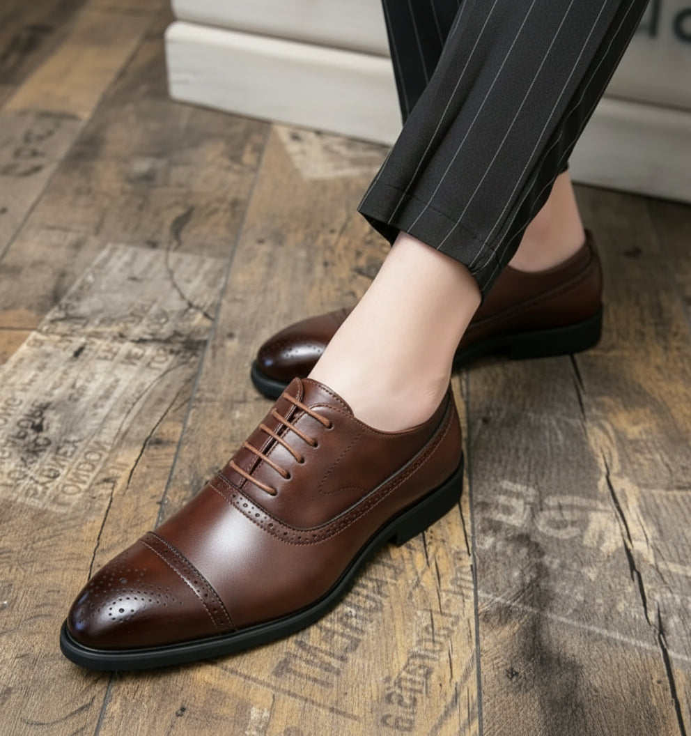 Brown leather shoes worn on a wooden floor with 'YOURDISH' branding.