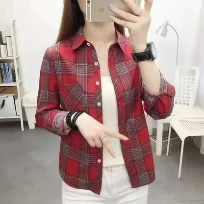 Person wearing a red plaid shirt in an indoor setting