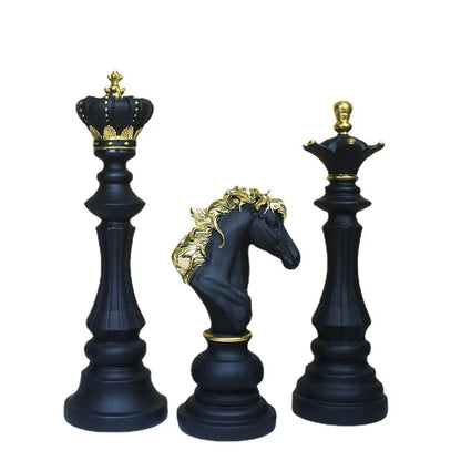 Black chess pieces with gold detailing on a white background