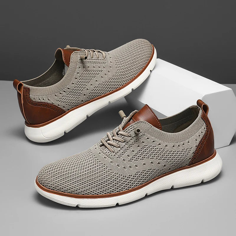 Pair of gray sneakers with brown accents on a gray background