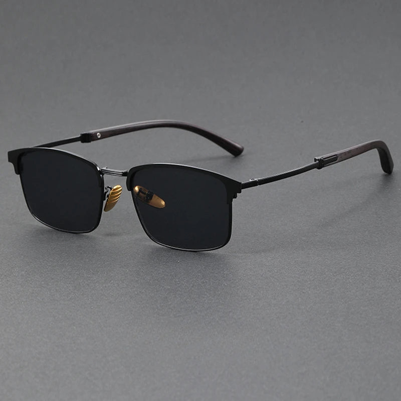 Sunglasses with black lenses and gold accents on a gray background