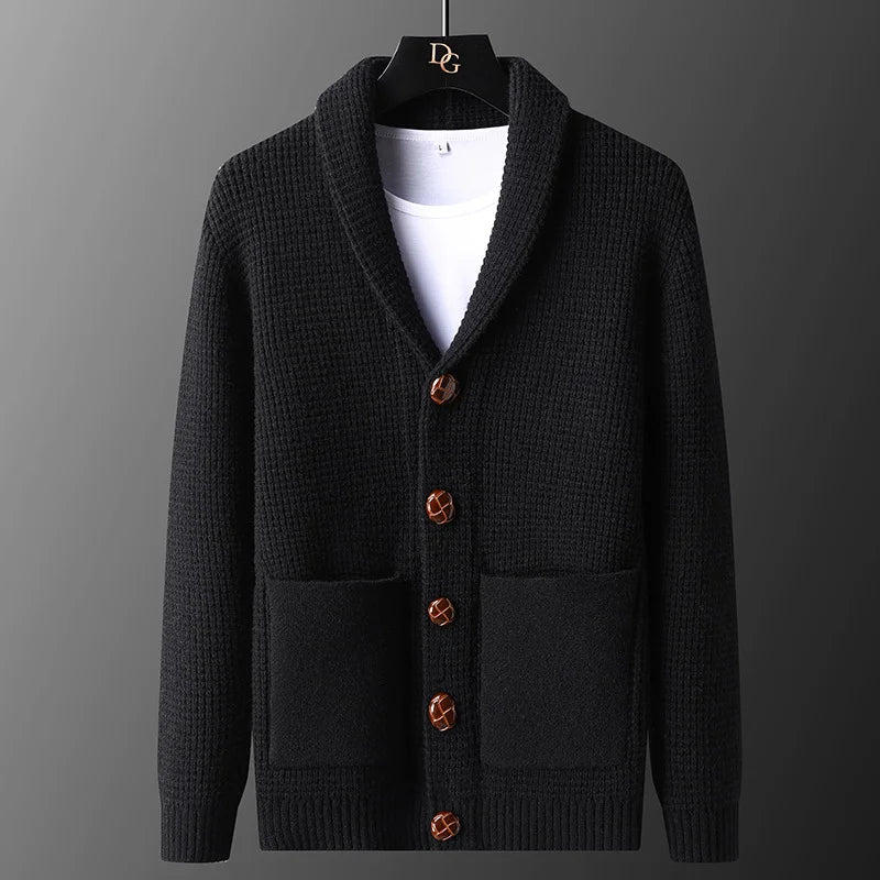 Black cardigan with brown buttons on a gray background