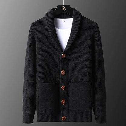 Black cardigan with brown buttons on a gray background