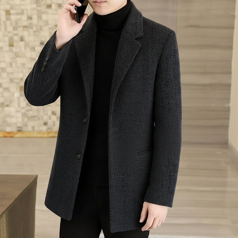 Person wearing a dark gray coat in an indoor setting