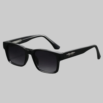 Black sunglasses with a brand logo on a gray background