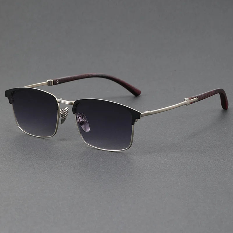 Sunglasses with dark lenses and maroon arms on a gray background