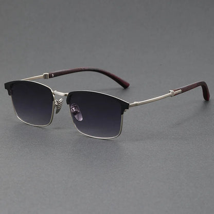 Sunglasses with dark lenses and maroon arms on a gray background