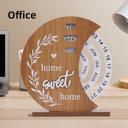 Wooden desk calendar with 'home sweet home' text on a desk.