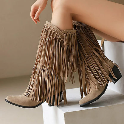 Tan fringe boots on a neutral background