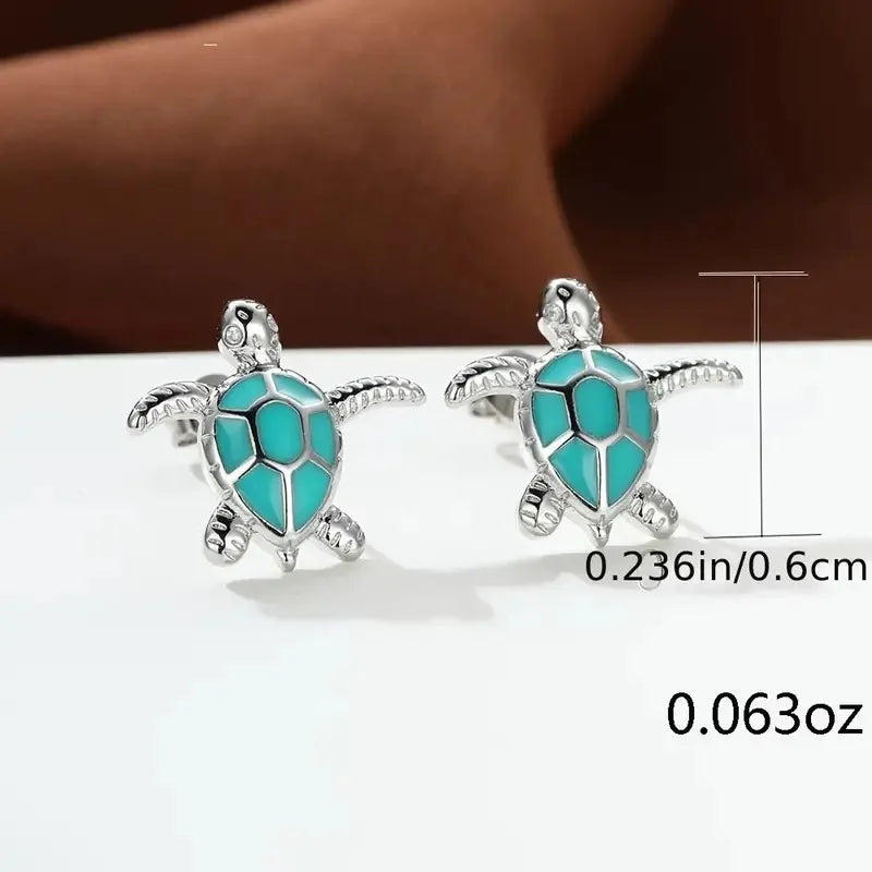 Turtle-shaped earrings with turquoise design on a white background