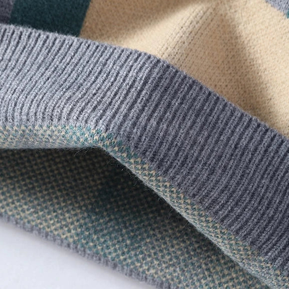 Close-up of a checkered fabric with blue, beige, and green colors on a white background.