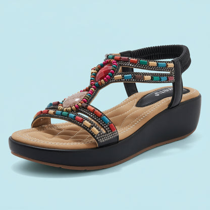 Wedge sandal with colorful beading on a white background