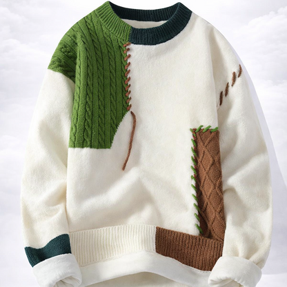 Color-blocked sweater with green, brown, and white sections on a white background