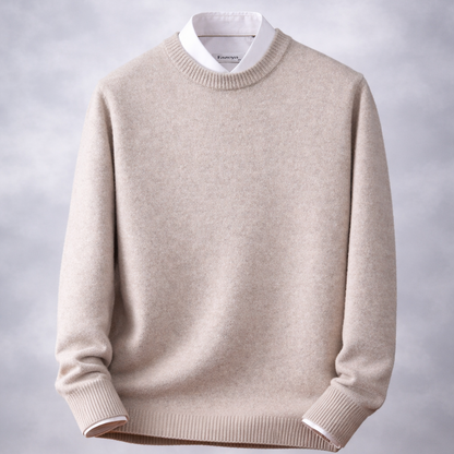 Beige sweater on a wooden table with a gray background