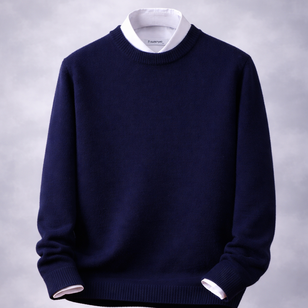 Navy blue sweater with white collar and cuffs on a wooden table against a gray background