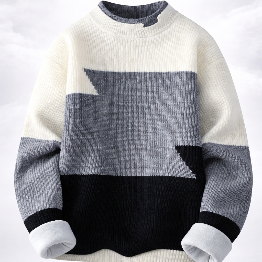 Color-blocked sweater with white, gray, and black sections on a light gray background