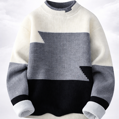 Color-blocked sweater with white, gray, and black sections on a light gray background